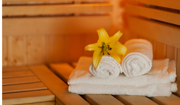 Folded Towels and a flower in a sauna.